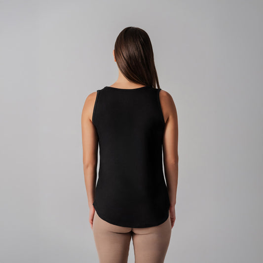 Person wearing a black sleeveless top against a gray background