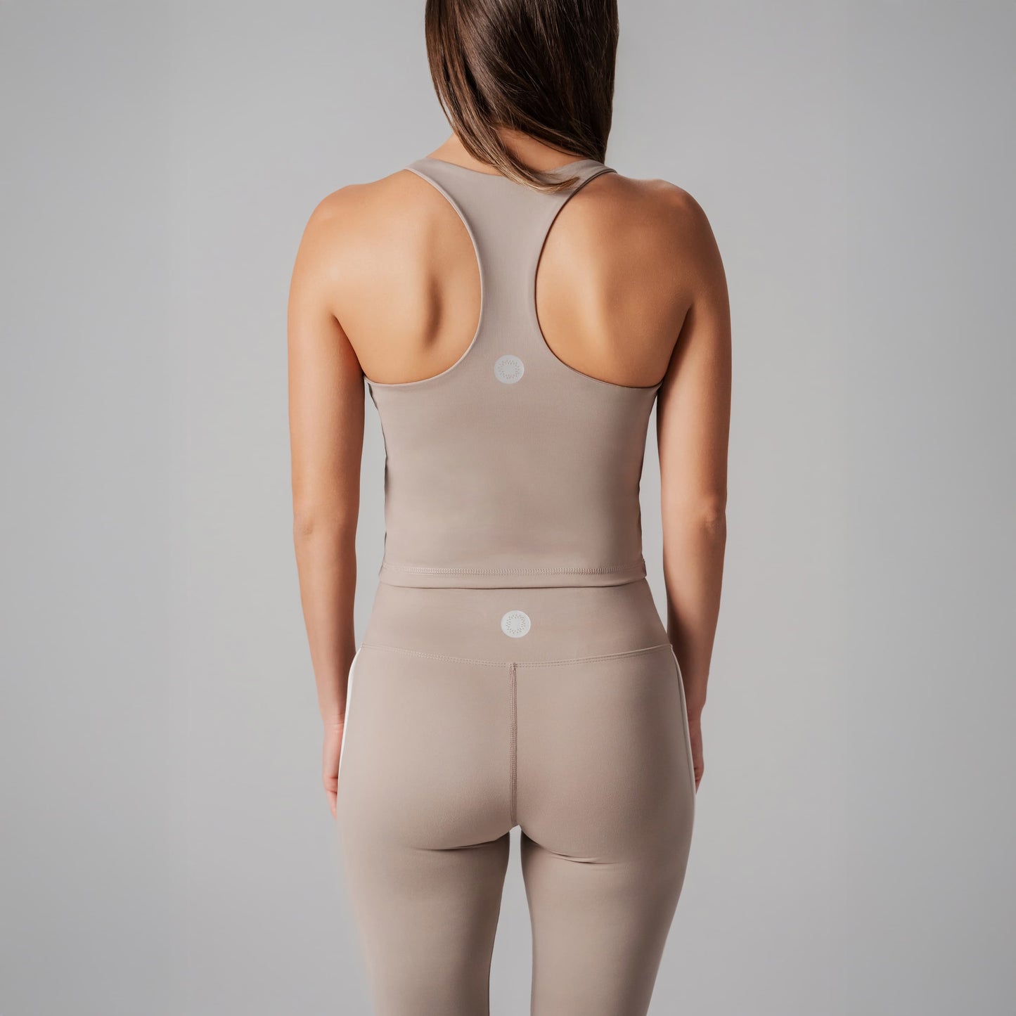 Beige Spots top worn by a person on a gray background