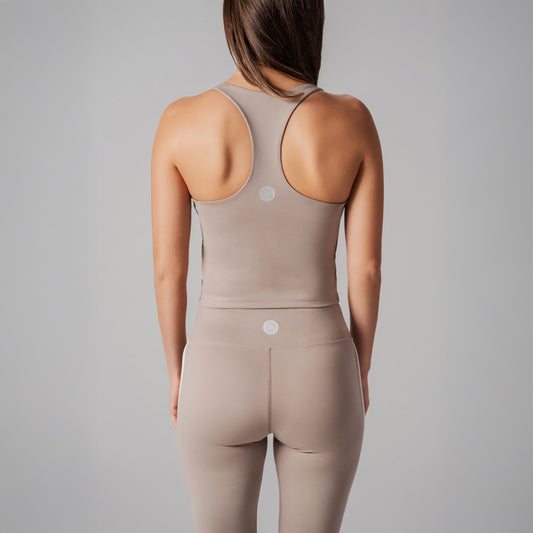 Beige Spots top worn by a person on a gray background