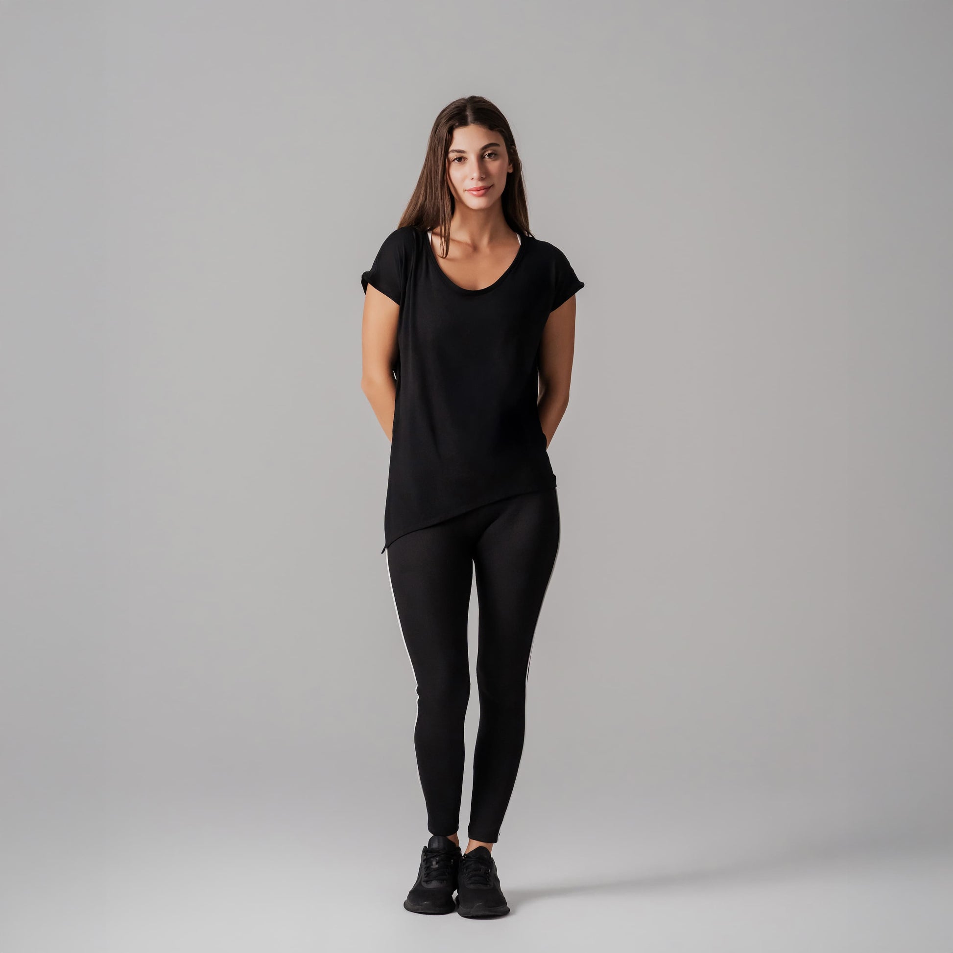 Woman wearing a black outfit on a gray background