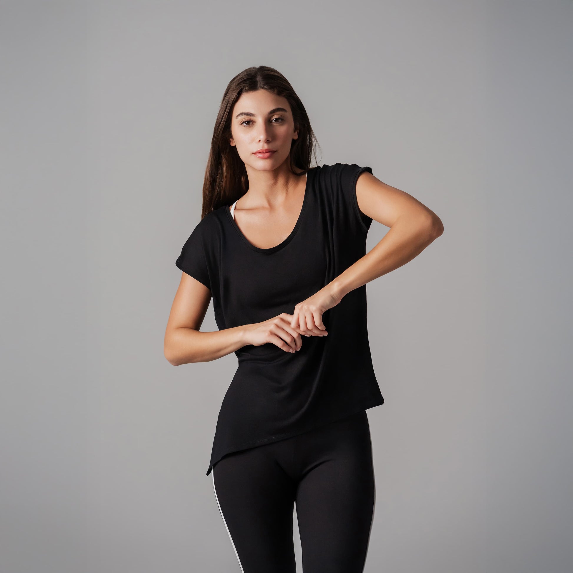 Woman wearing a black outfit on a gray background