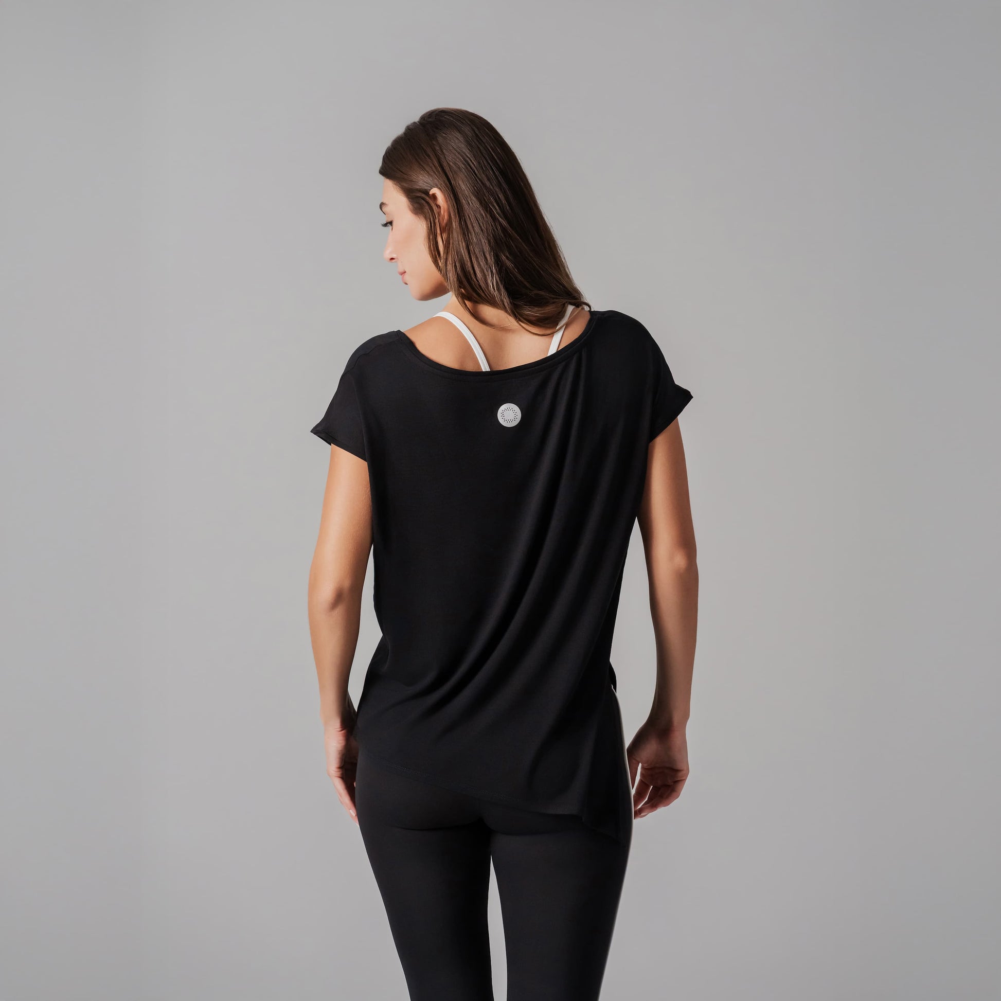 Woman wearing a black outfit with a gray background