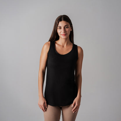 Woman wearing a black tank top against a gray background